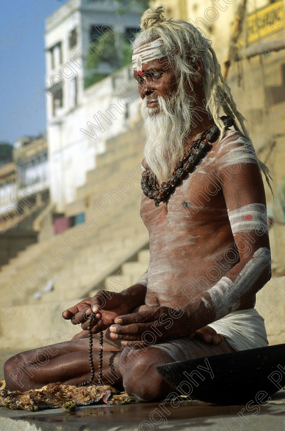 Varanasi Sadhu 
 An Indian Sadhu (Holyman) meditates on the bathing ghats in Varanasi, India. 
 Keywords: India, Varanasi, Banares, River, Ganges, Uttar Pradesh, Sadhu, Holyman, Hindu, Hinduism, Religion, Meditation, Shiva, beard, topknot, ashes, ghats, Kashi