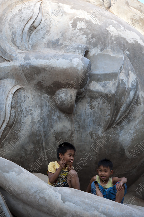 On the Buddha 1 Vientiane 
 Keywords: Laos, Vientiane, Buddha, statue, Boys, playing